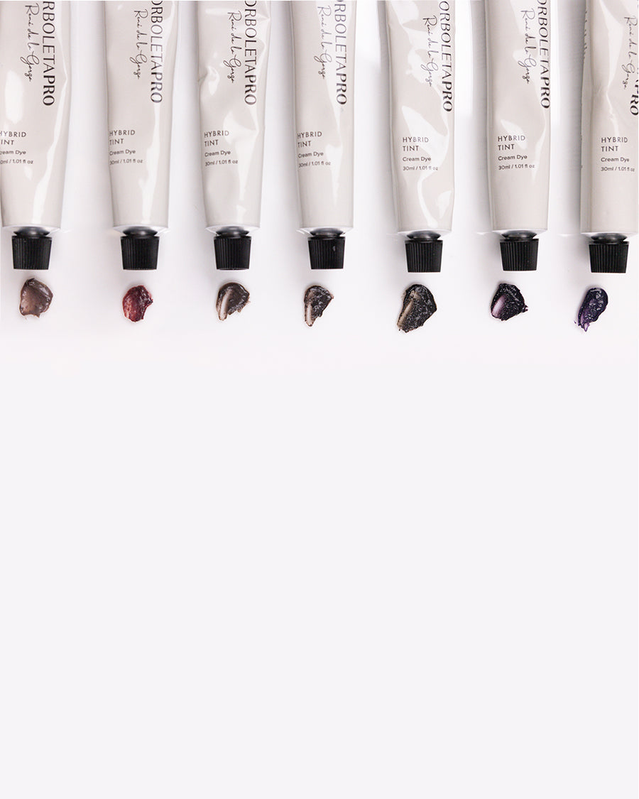 All seven shades of BorboletaPro's Hybrid Tint laying against a white marble surface